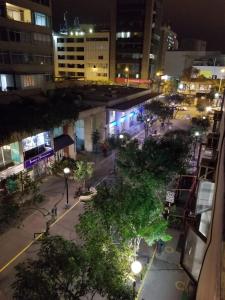 a city street at night with trees and street lights at Waldorf in Lima