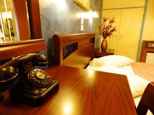 
a desk with a phone and a lamp on it at Pergamos Hotel in Athens
