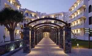a hallway of a building with an archway at Atlantica Akti Zeus Hotel in Amoudara Herakliou