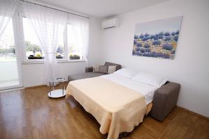 1 dormitorio con cama y sofá en City Center Accommodation, en Zadar