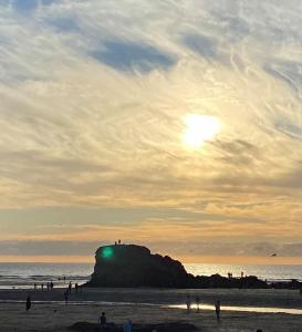 a group of people on the beach at sunset at Surf's Up in Perranporth, Cornwall Coastal Holidays in Perranporth