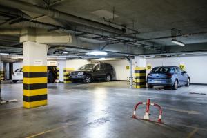 a parking garage with several cars parked in it at Finger Guest Rooms in Krakow