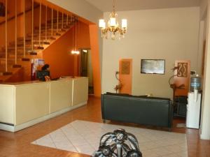 a lobby with a desk and a staircase and a room at Bonito Hotel in San Rafael