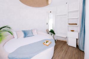 a white bedroom with a bed with a tray on it at Ilica Hotel Spa & Wellness Resort in Çeşme