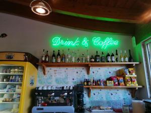 a bar with a sign that reads drink and beverage at Residence Le Palme in Grottammare