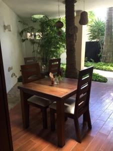 a wooden dining room table and chairs on a patio at Mi Casa en Cozumel in Cozumel
