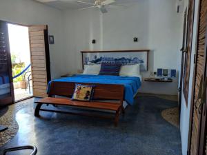 a bedroom with a bed and a table and a fan at Mi Casa en Cozumel in Cozumel