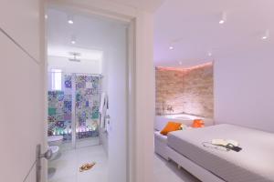 a bedroom with a bed and a brick wall at Amalfi Suite Boutique Hotel in Amalfi