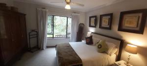 a bedroom with a large bed and a window at Cybele Lodge Boutique Bed and Breakfast in Hillcrest