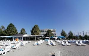 a bunch of lounge chairs on a beach at Mirage Hotel - Struga in Struga