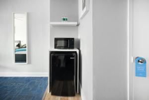 a kitchen with a refrigerator and a microwave at Lorraine Hotel in Miami Beach