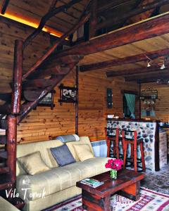 a living room with a couch and a bar at Vila Mali Tornik in Zlatibor