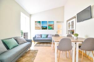 a living room with a couch and a table at Elevator's Beach House in Albufeira