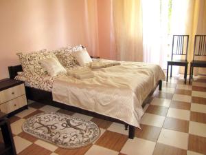 a bedroom with a bed and a tiled floor at Перлина in Morshin