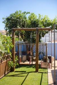 a swing set in a yard with grass at NINHO SALOIO in Venda do Pinheiro