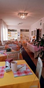 リド・ディ・カマイオーレにあるHotel Ristorante La Terrazzaのテーブルと椅子のあるレストラン、ベッドのある部屋