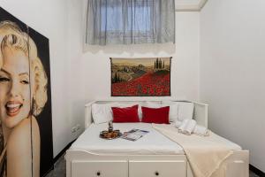 a bedroom with a bed with a painting on the wall at Fantastic house near the station Free parking in Genoa