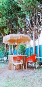 a table and two chairs under an umbrella at CABANA DO SOL in Torres Vedras