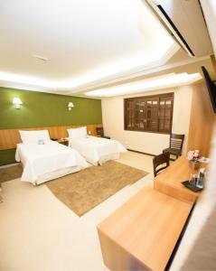 En eller flere senge i et værelse på Hotel Dom Otto