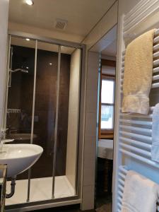 a bathroom with a shower and a sink at Landhaus Sonnenberg in Sankt Anton am Arlberg