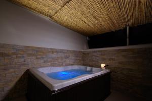 a bath tub in a room with a brick wall at Amalfi Suite Boutique Hotel in Amalfi +37 photos