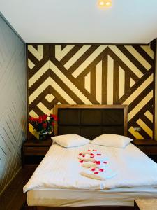 a bed with red hearts on it in a room at Hotel Monysto in Bukovel