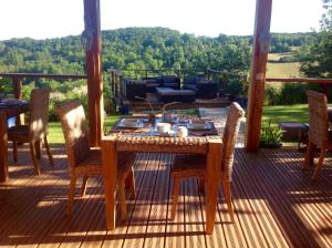 a table and chairs on a deck with a view at Domaine de Terrac in Rimont