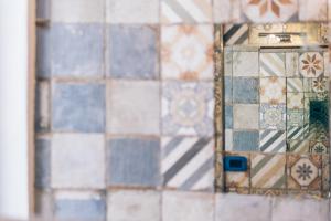 un reflet d'un mur en carrelage dans un miroir dans l'établissement AQUILA D'ORO TRIESTE, à Trieste