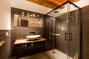 ein Bad mit einem Waschbecken und einer Glasdusche in der Unterkunft CA3 - Duplex de dos dormitorios en el Centro Histórico con garaje in Saragossa
