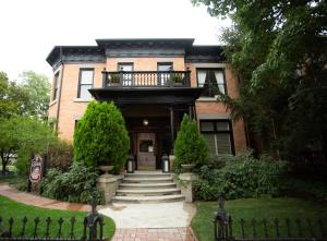 a brick house with a balcony on top of it at Ellerbeck Bed & Breakfast in Salt Lake City