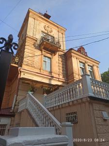 a tall building with a balcony and stairs on it at Вілла Графа in Lviv