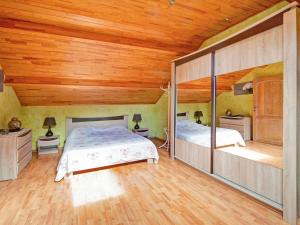 two beds in a room with wooden ceilings at Enjoy a relaxing break for two and discover Durbuy in Biron