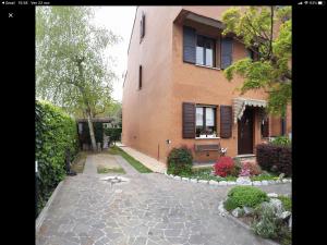 a house with a stone walkway in front of a building at B&B Accanto al Focolare in Udine