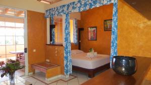 a bedroom with a bed in the corner of a room at Sunset Hill Lodge in Bora Bora +47 photos