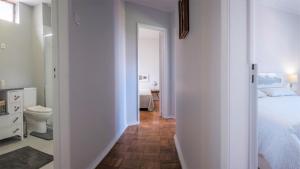 a white bedroom with a bed and a toilet at BABhouse Casa da Colmeia - Coração do Douro in São João da Pesqueira +34 photos