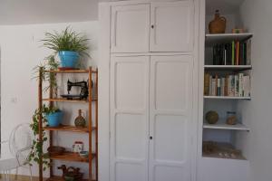a room with a white cabinet with books at Los Trigos, Casa Rural in Montejaque