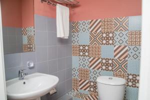 a bathroom with a toilet and a sink at Hi hotel in Almaty