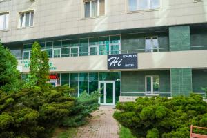 a building with a sign on the front of it at MAZA Almaty in Almaty