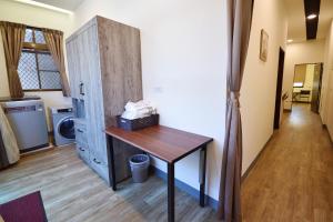 a room with a table and a cabinet and a hallway at Xiang Quie B&B in Taitung City