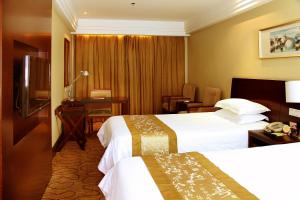 a hotel room with two beds and a television at Yan'an Hotel in Shanghai