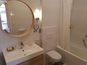 a bathroom with a sink and a toilet and a mirror at Hôtel de Charme Brise Marine in Saint-Jean-Cap-Ferrat