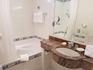 a bathroom with a sink and a tub at Hôtel de Charme Brise Marine in Saint-Jean-Cap-Ferrat +35 photos