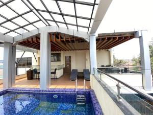 a house with a swimming pool and a patio at La Maison Royale South C in Nairobi