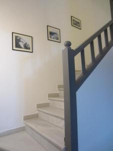 a staircase with three framed pictures on the wall at Hotel Llorca in Platja de l’Almadrava