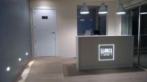 an office with a counter with a sign on it at Hotel Llorca in Platja de l’Almadrava