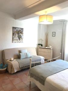 a bedroom with two beds and a dresser at Market in Antibes