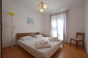 - une chambre avec un lit et 2 serviettes dans l'établissement Apartments Adriana, à Omišalj