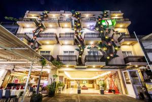 a building with a christmas tree on the side of it at The Tusita Hotel in Kuta