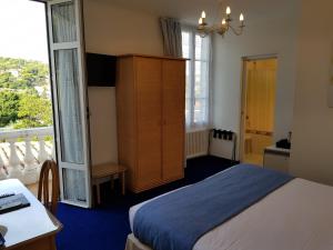 a bedroom with a bed and a large window at Hôtel de Charme Brise Marine in Saint-Jean-Cap-Ferrat