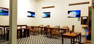 a dining room with wooden tables and chairs at Arrys Watukarung Surfcamp in Kalak